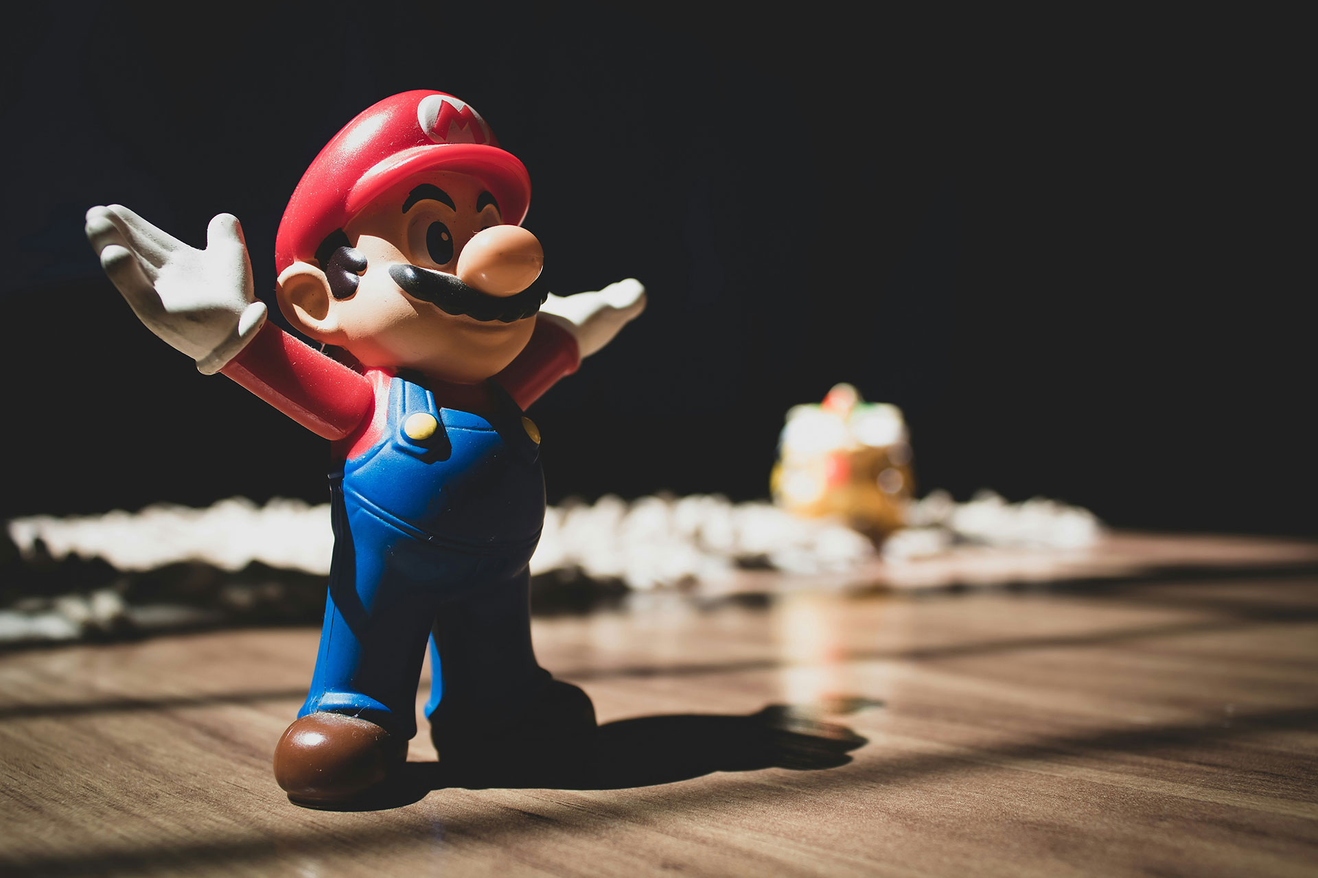 A small statue of Mario with his arms lifted outwards