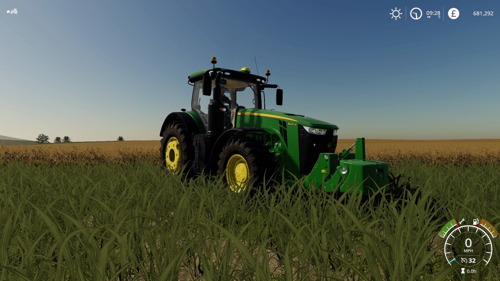 Green John Deere tractor in field