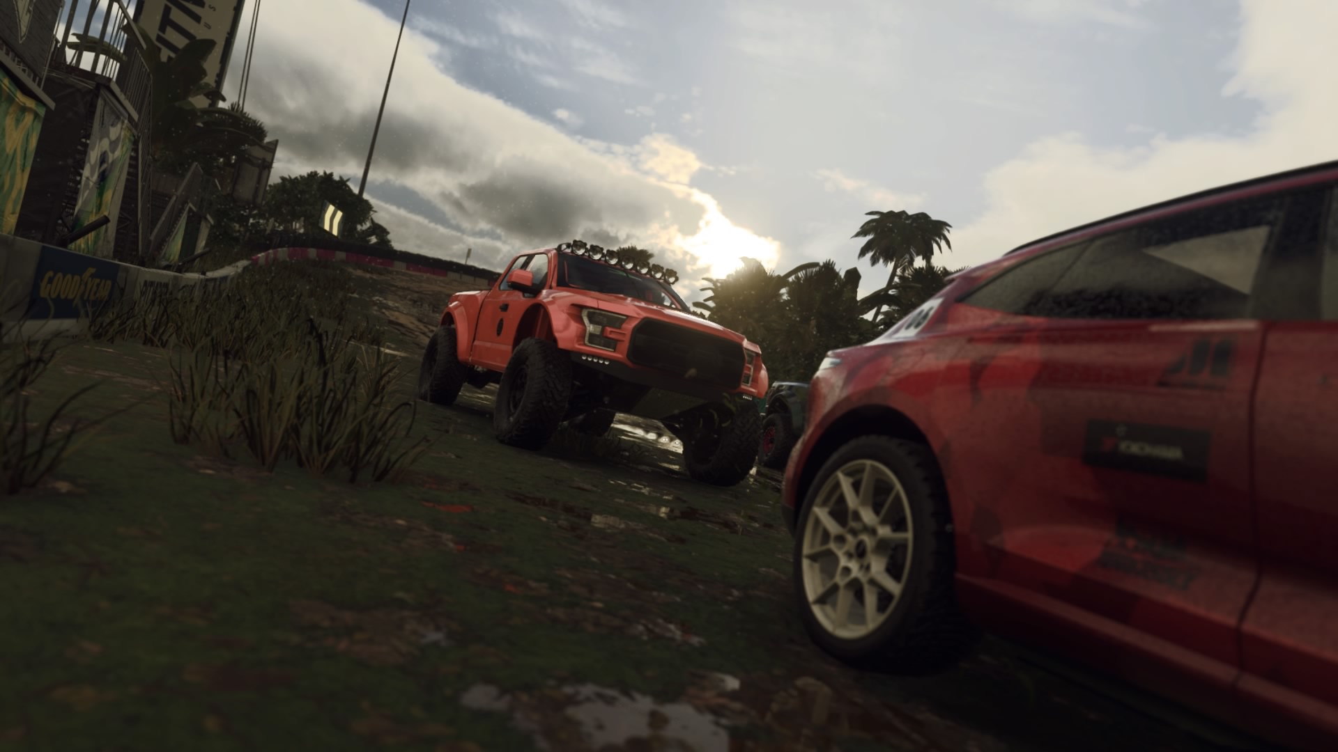 Cars racing through dirt track