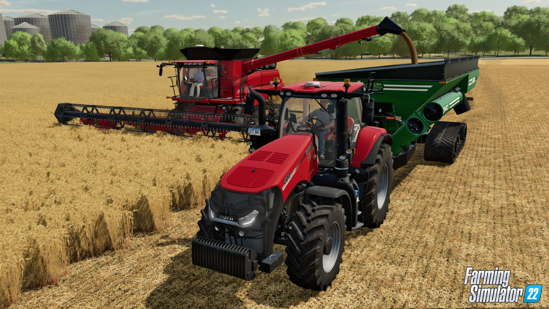 A combine harvester loading up a tractor and trailer