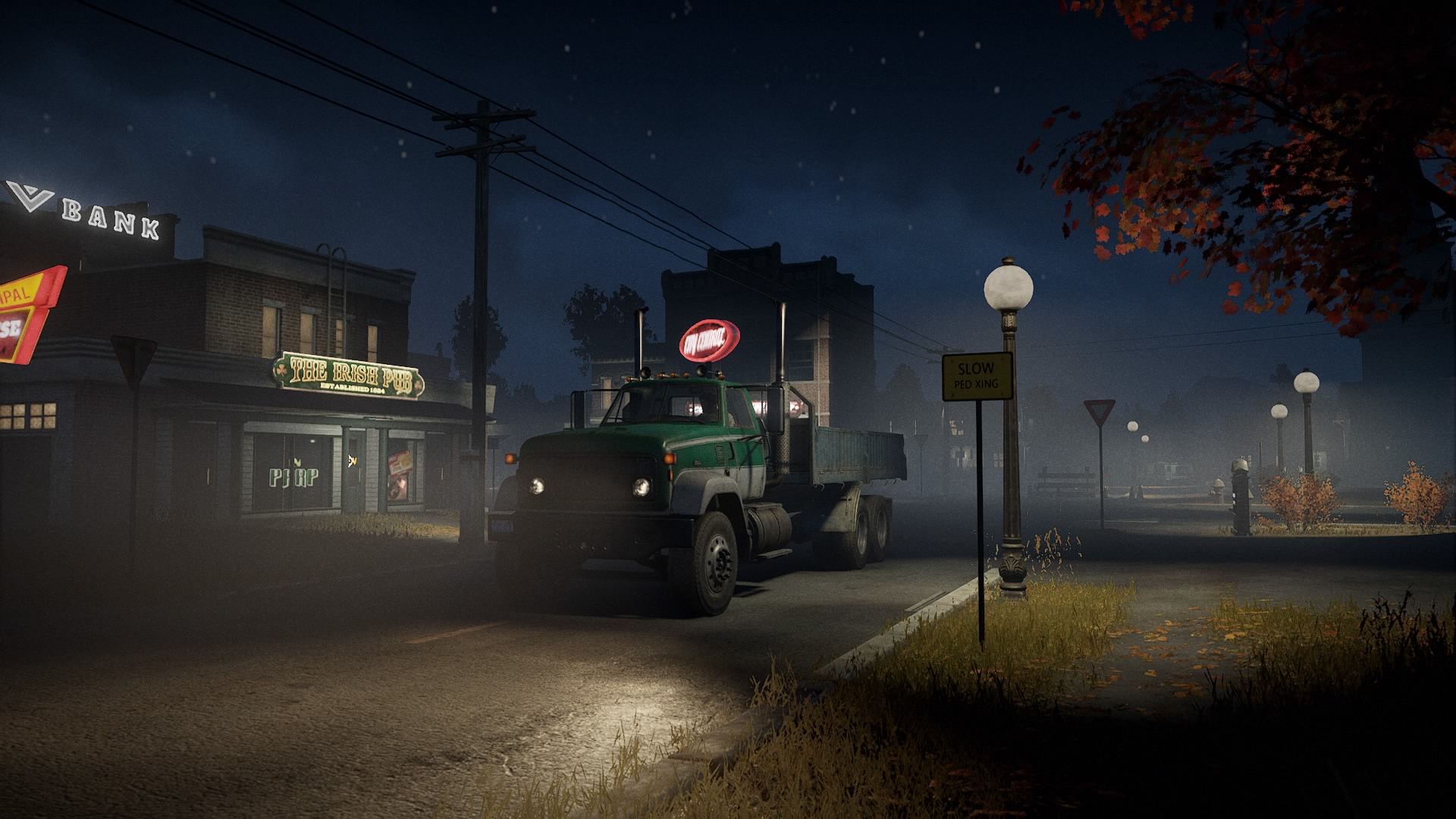 A truck driving through a dimly lit town