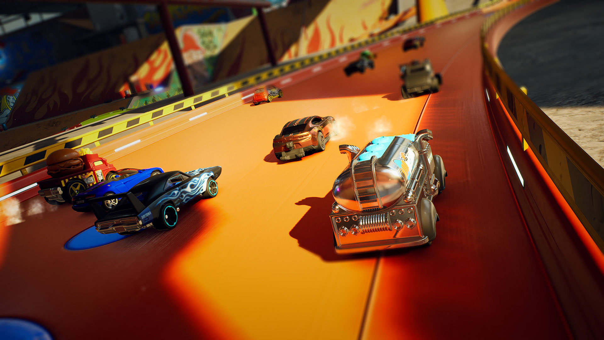 A bunch of Hot Wheels cars racing on an orange track